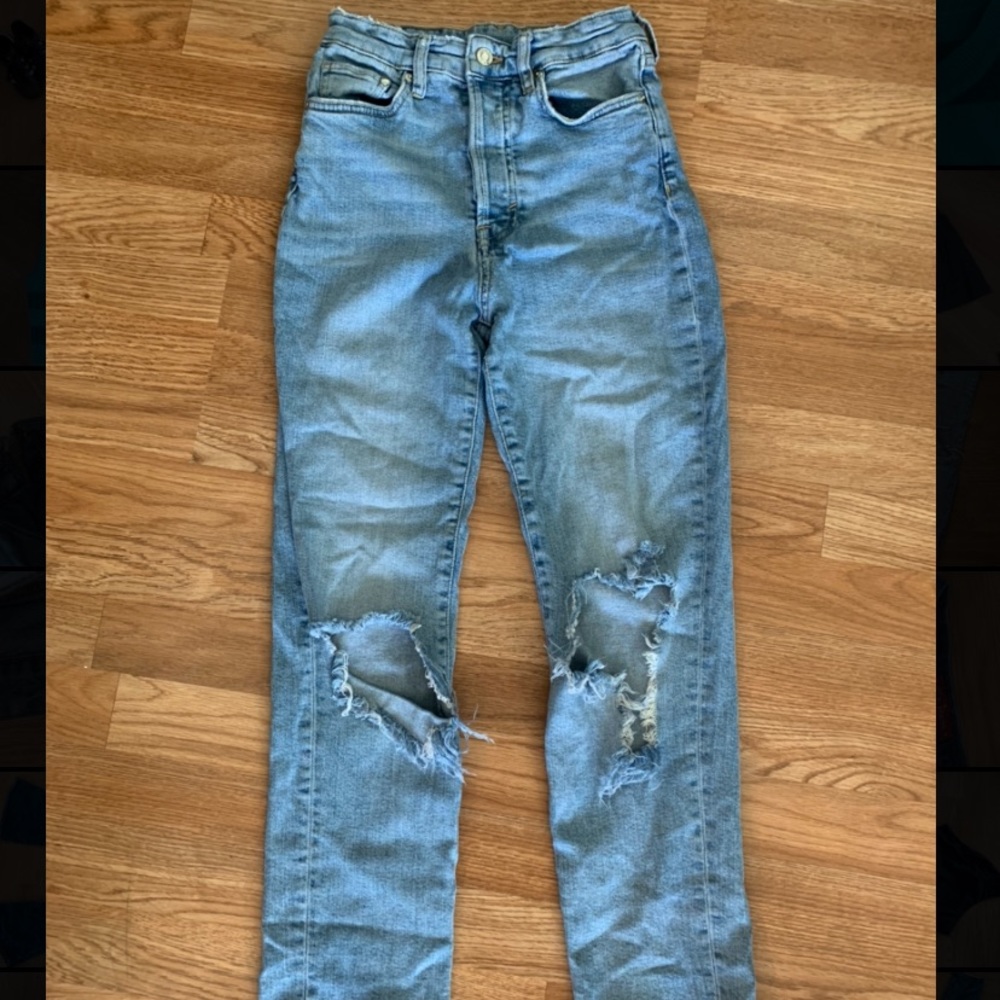 blue wash mom jeans with two rips on the knees